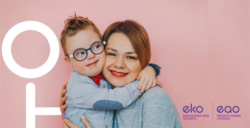 Adult hugging young child with glasses 